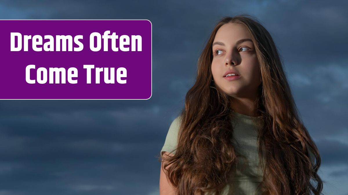 Teen girl with long curly hair on sky background.