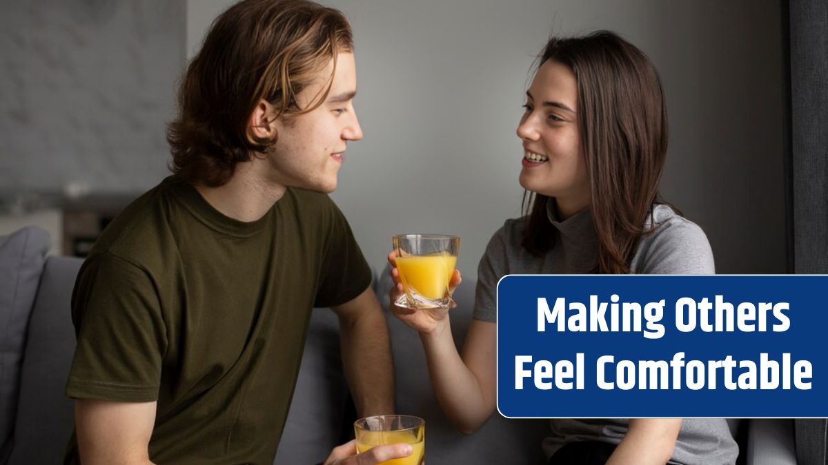 Woman smiling at boyfriend while holding glass of orange juice.