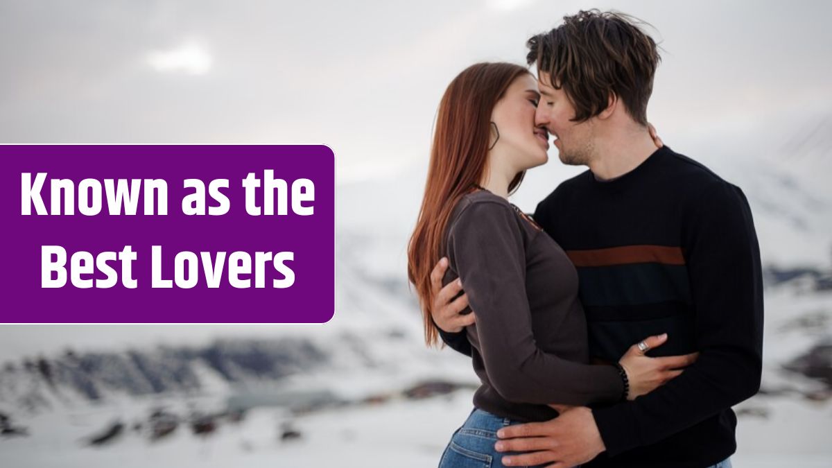 Couple in love kissing on snowy mountains.